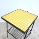 Small vintage yellow side table with magazine rack.