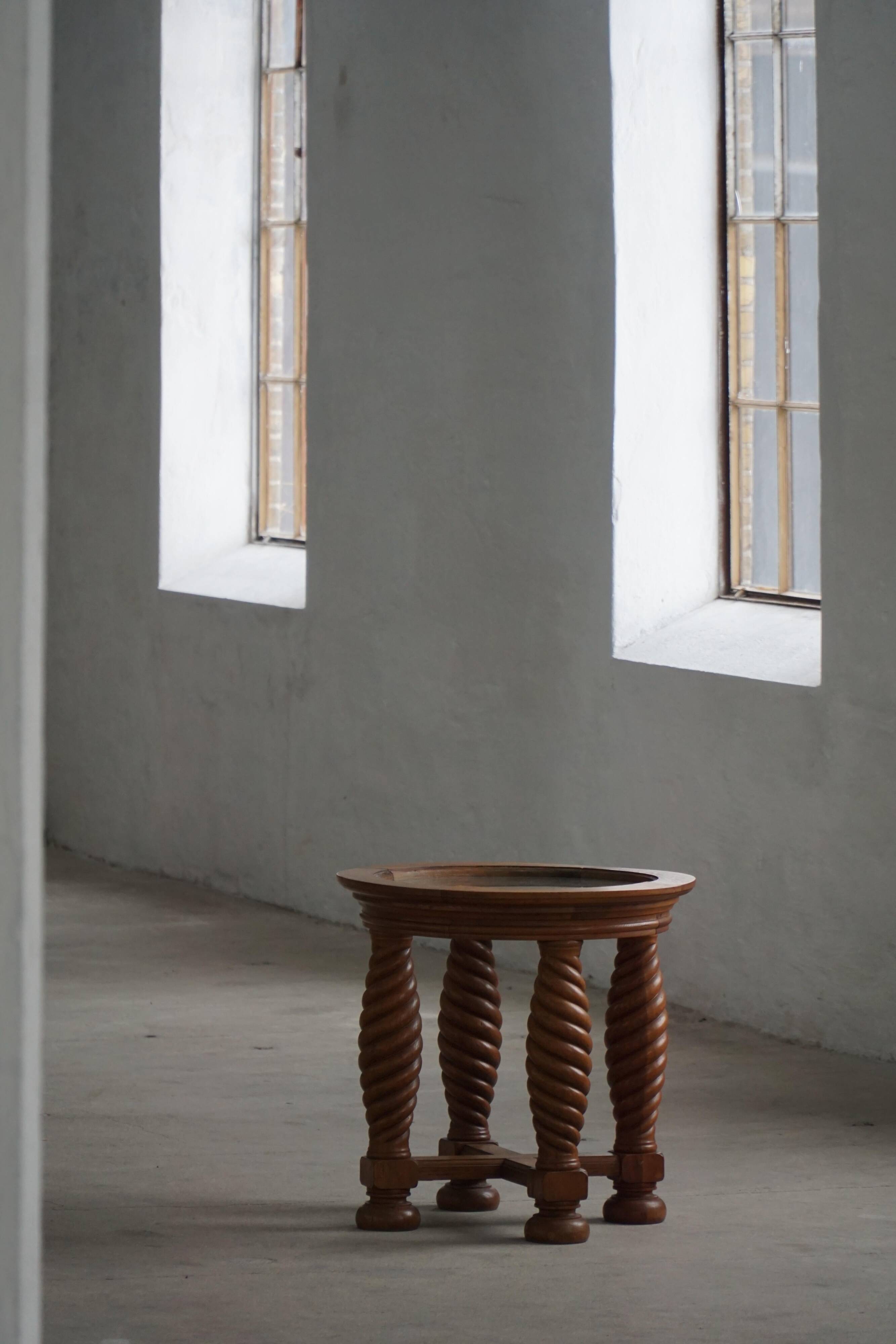 Modern Danish mid-century table, made of oak with spiral turned legs and a glass top, 1950s.