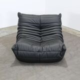 Togo armchair and footrest in black leather by Ligne Roset, designed by Michel Ducaroy.