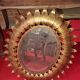 Golden metal sun mirror with leaf decoration