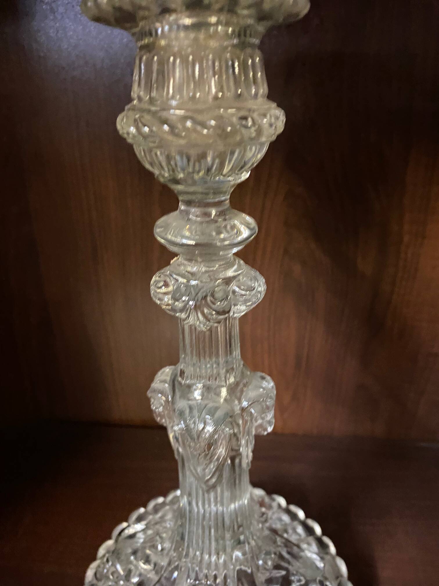 pair of cut glass candlesticks with lion and ram head decor, late 19th century