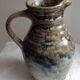 Enamelled ceramic pitcher, signature mb the terminal