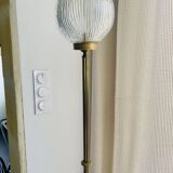 Floor lamp in gilded brass and round glass globe