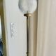 Brass floor lamp with a round glass globe