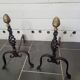 Old pair of wrought iron pegs with brass pine cone