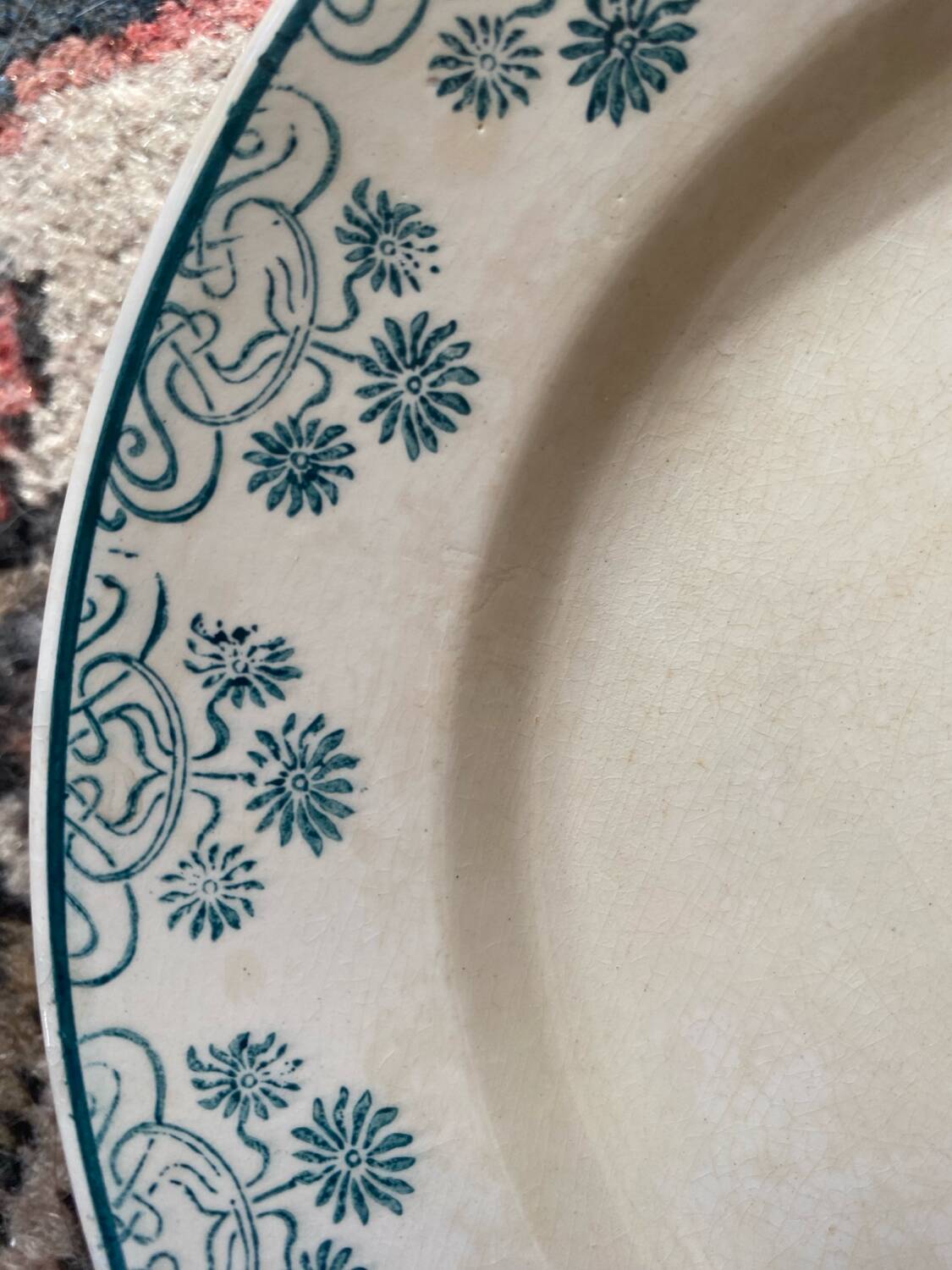 3 flat plates in ironstone with a floral green border.
