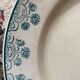 3 flat plates in ironstone with a floral green border.