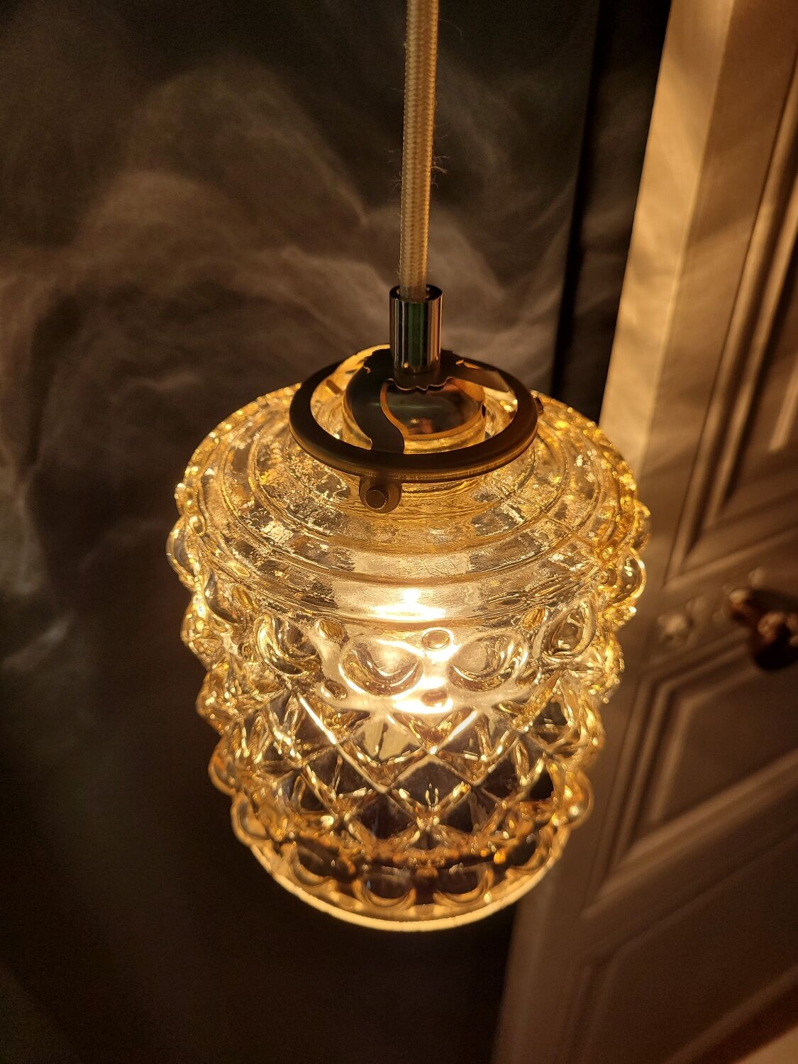 Moulded glass lamp with a cubic-spherical relief design.