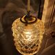 Moulded glass lamp with a cubic-spherical relief design.