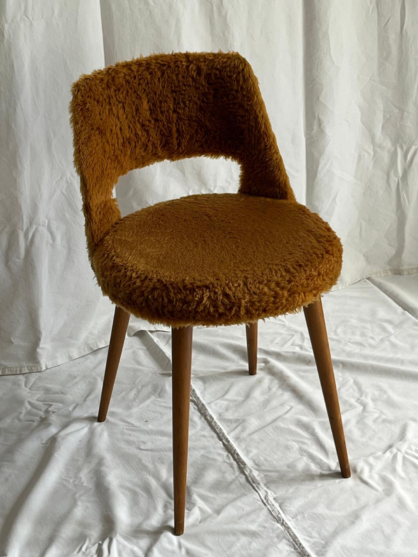 Camel barrel chair with faux fur by Baumann