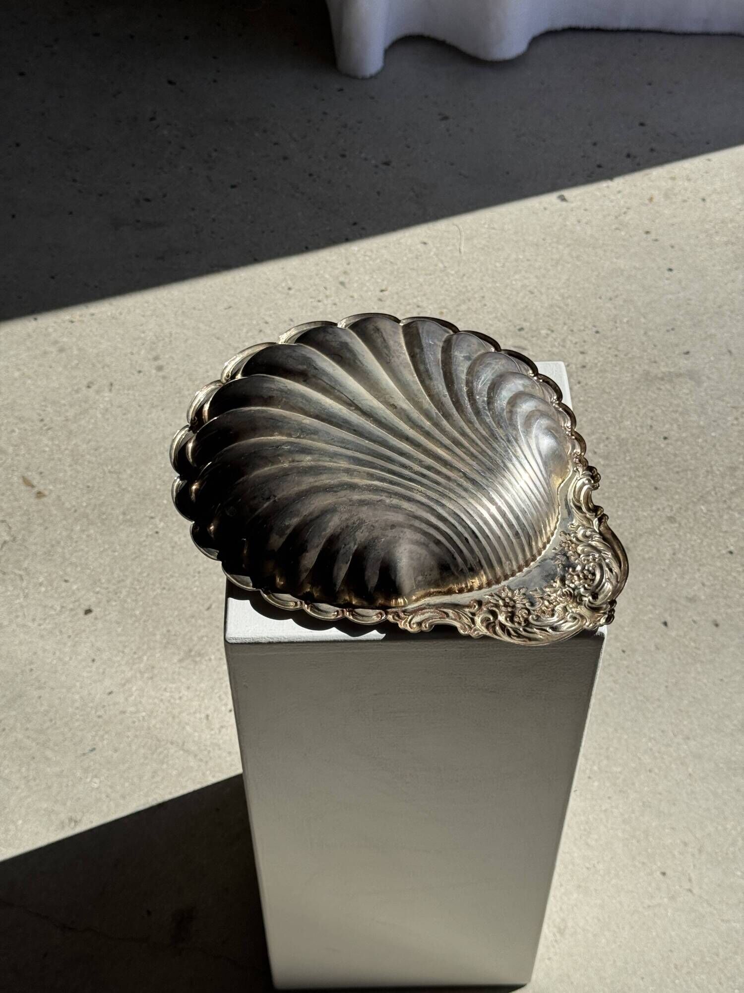 Large antique silver-plated bowl in the shape of a shell.