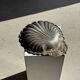 Large antique silver-plated bowl in the shape of a shell.