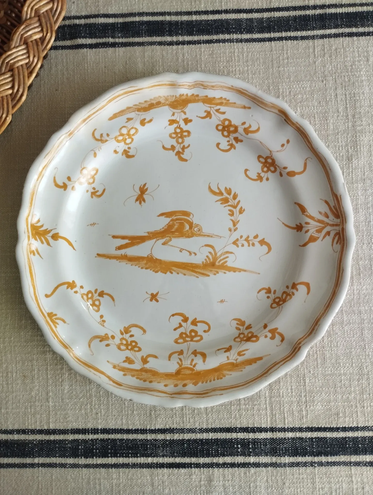 Pair of antique plates with a bird of paradise design in the style of Moustiers.
