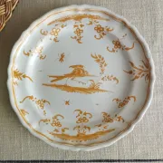 Pair of antique plates with a bird of paradise design in the style of Moustiers.