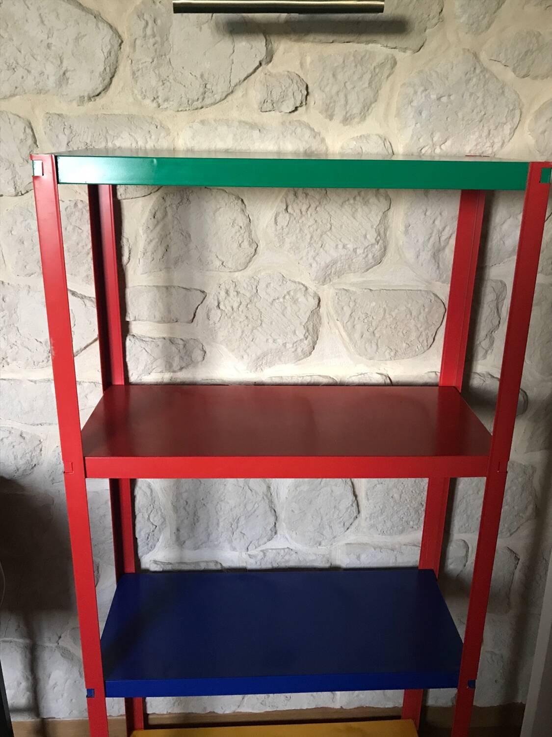 Shelf on multi-colored metal feet