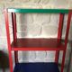 Shelf on multi-colored metal feet