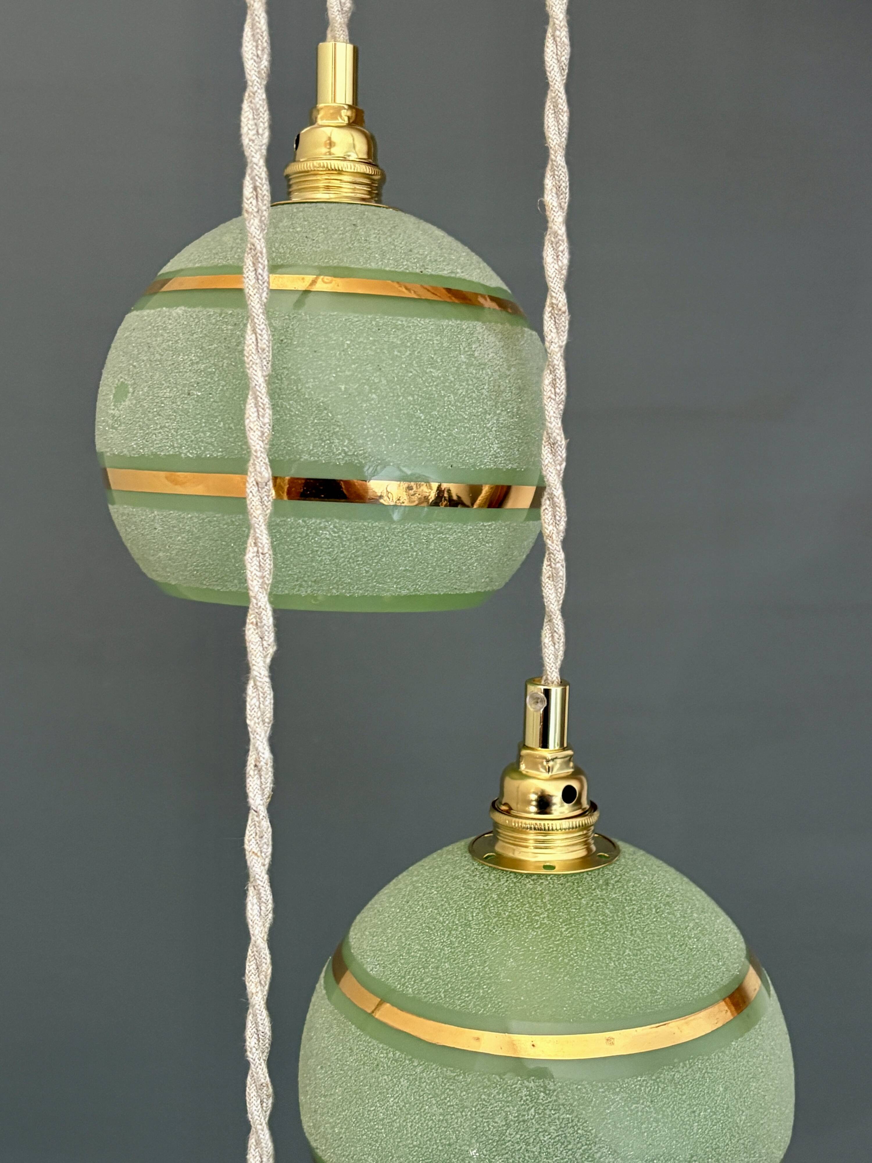 Suspension triple vintage glass globes in frosted green and gold.