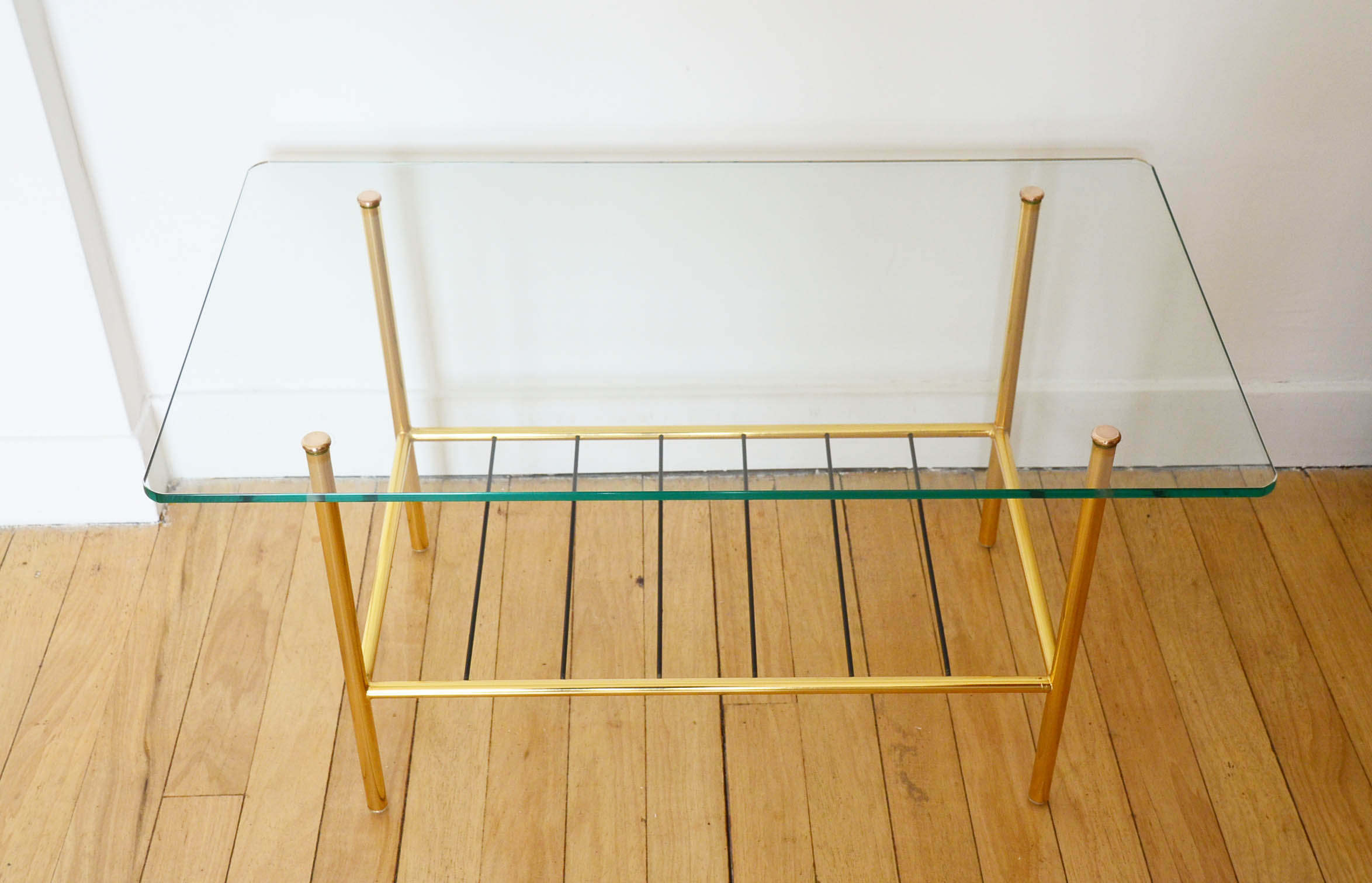 Glass coffee table with magazines holder