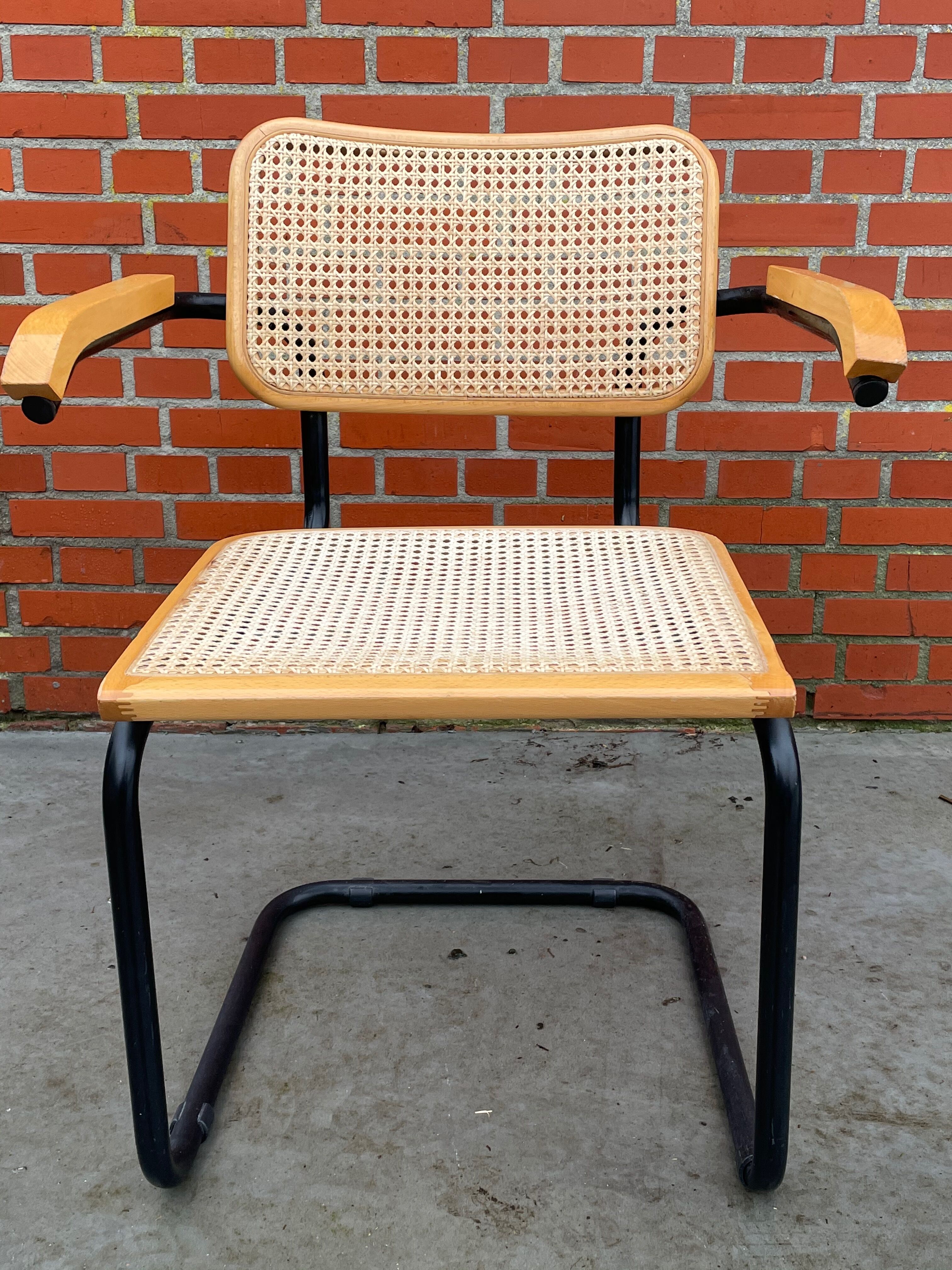 Cesca model chair designed by Marcel Breuer with black-framed armrests