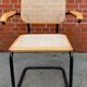 Cesca model chair designed by Marcel Breuer with black-framed armrests