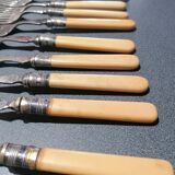 Old silver fish forks with bone handles