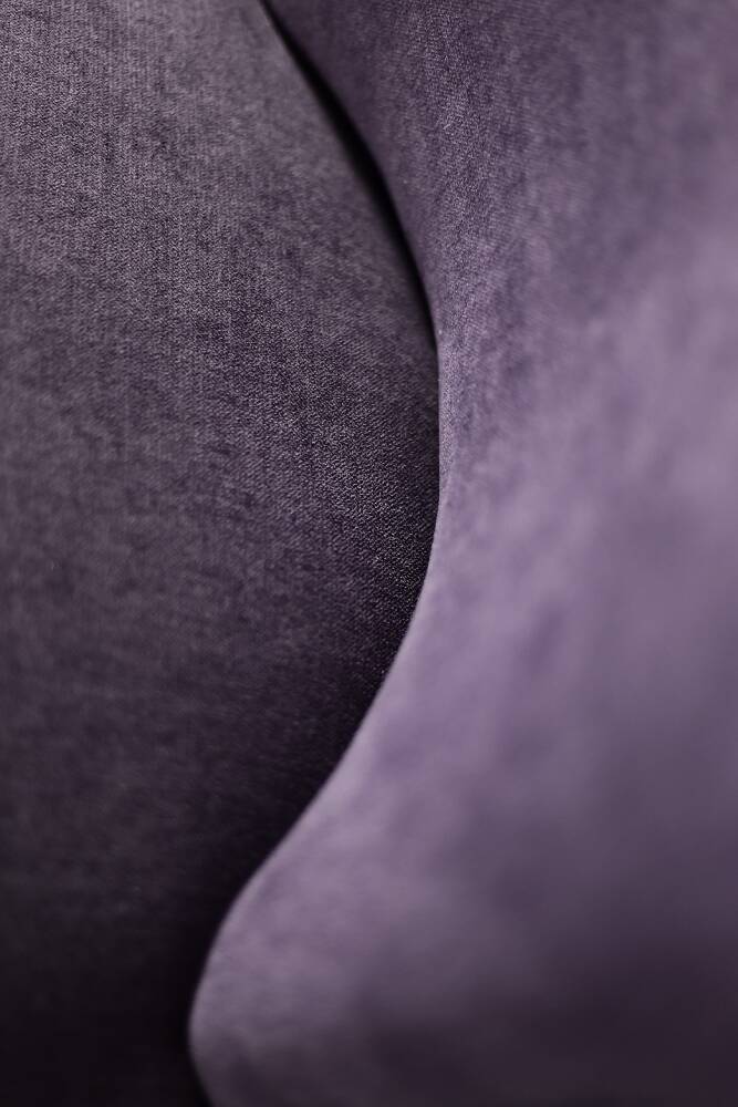 High-backed wing chair in oak and purple fabric, vintage Scandinavian style from the 1950s.