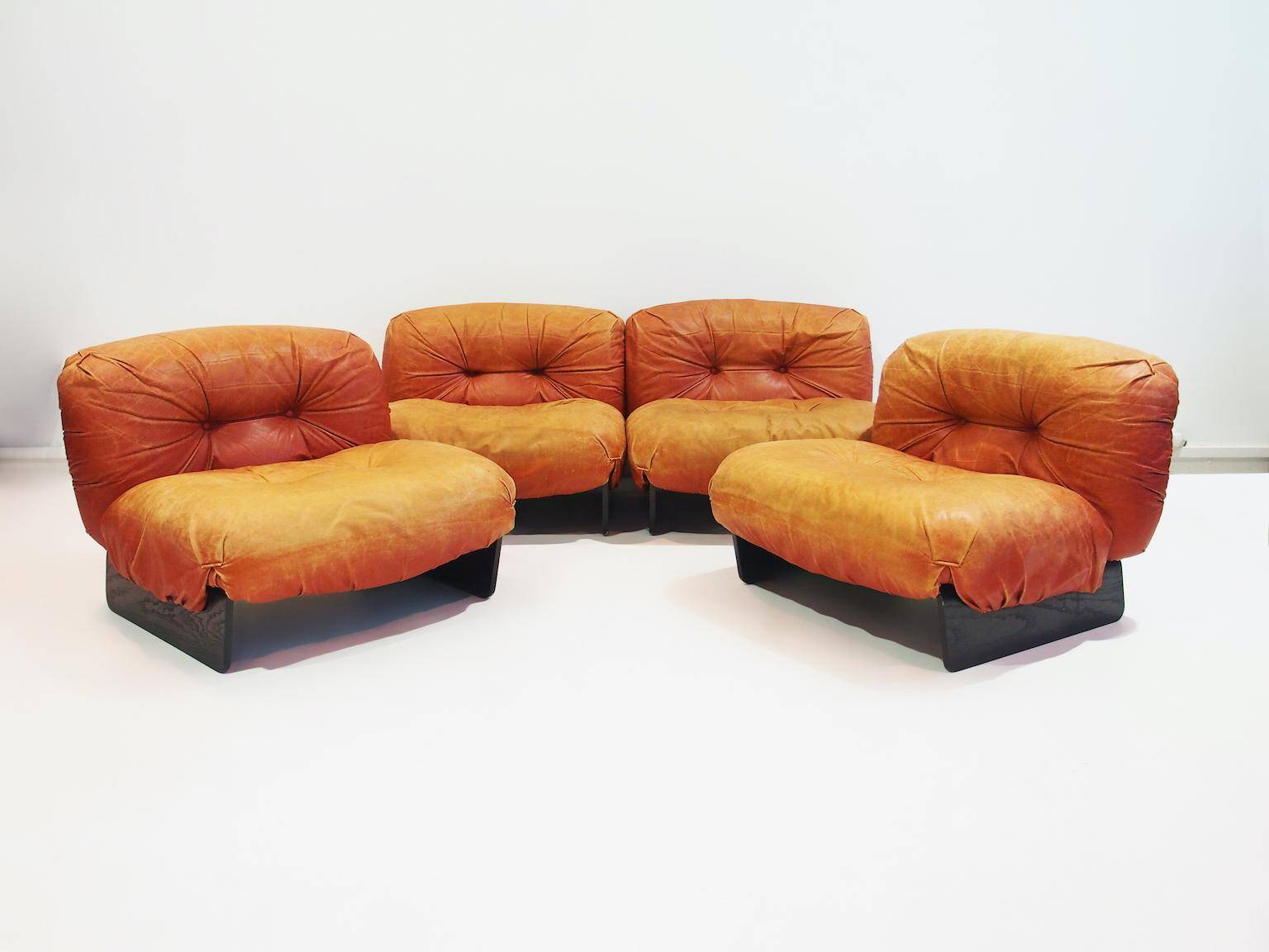 Set of four modular sun loungers by Giuseppe Munari upholstered in cognac leather.