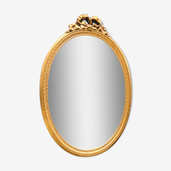 Mirror oval golden ribbon of Louis XVI style