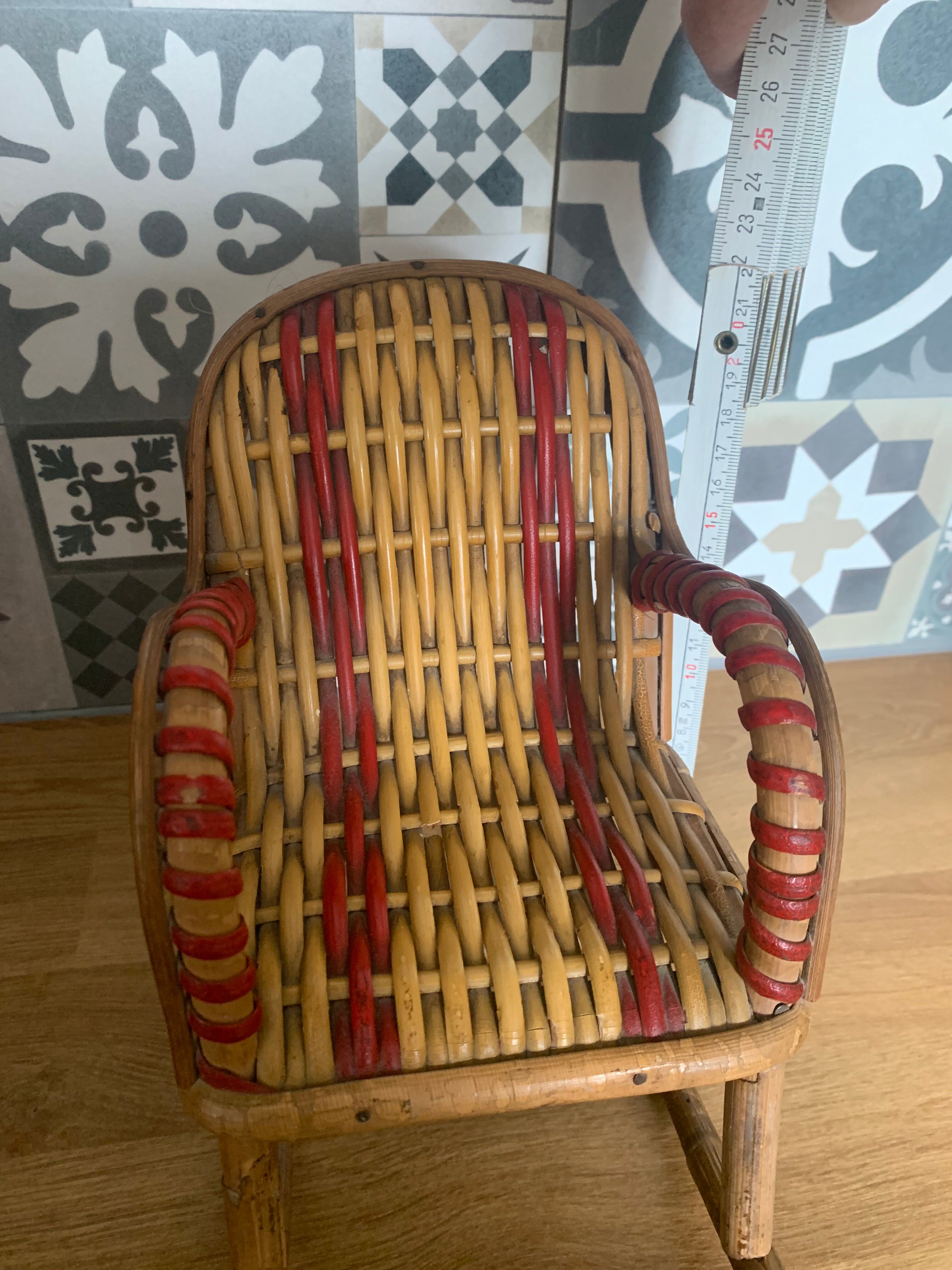 Antique miniature rocking chair in rattan for dolls.