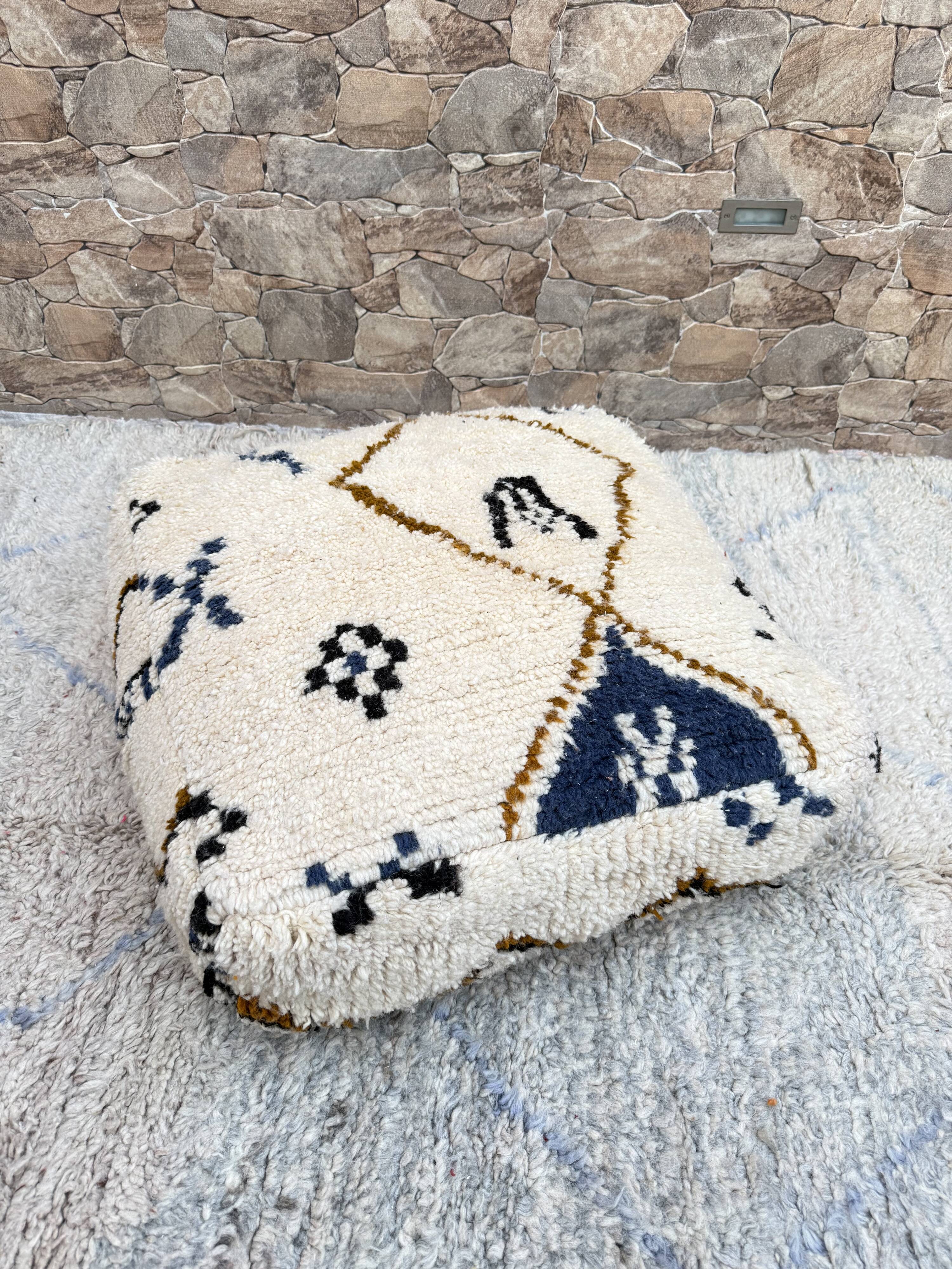 Berber floor pouf: Handwoven Moroccan wool cushion.