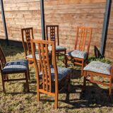 Set of 8 teak lounge chairs with high backs and zebra-striped seats