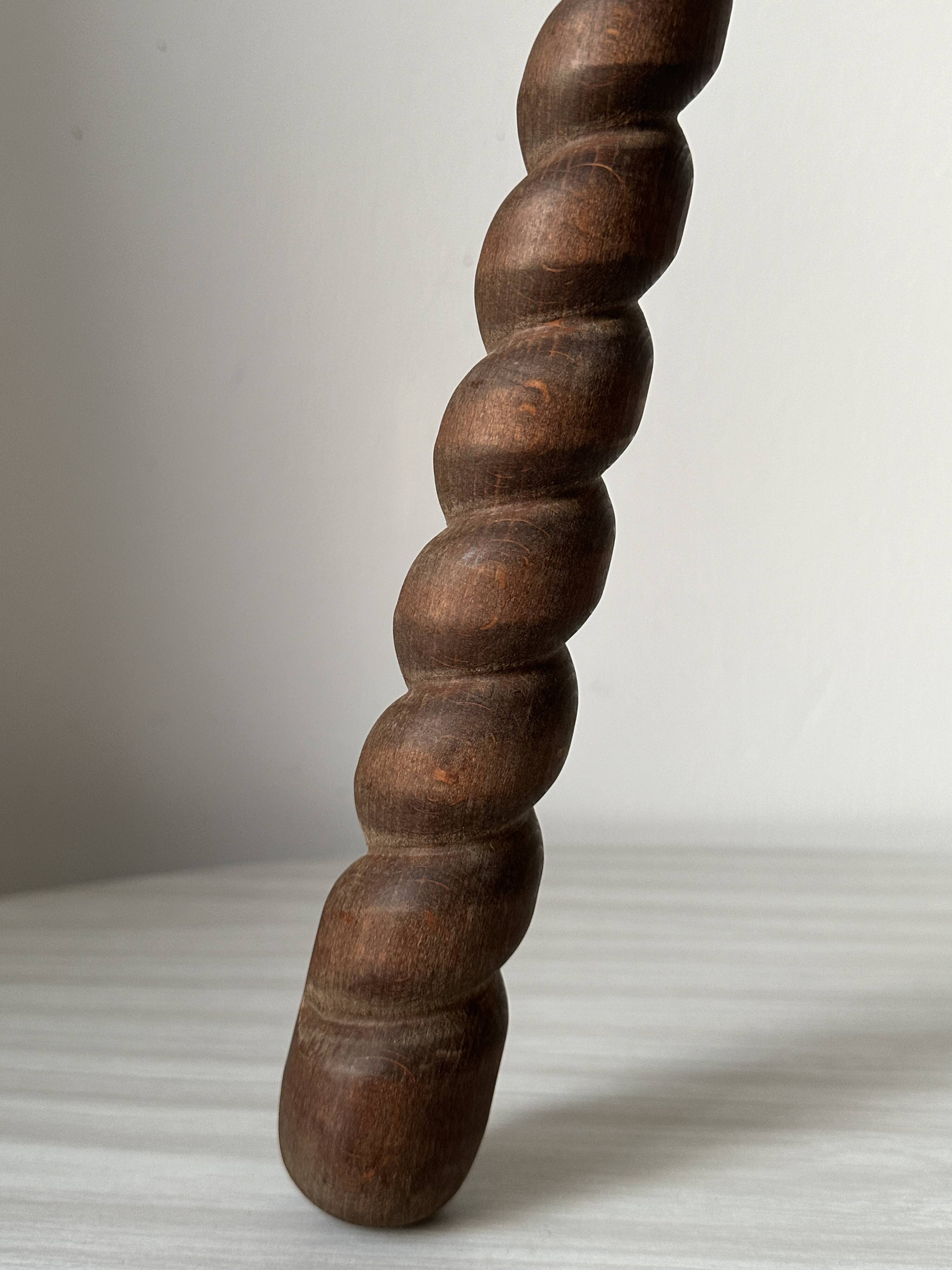 Wooden stool with three twisted legs