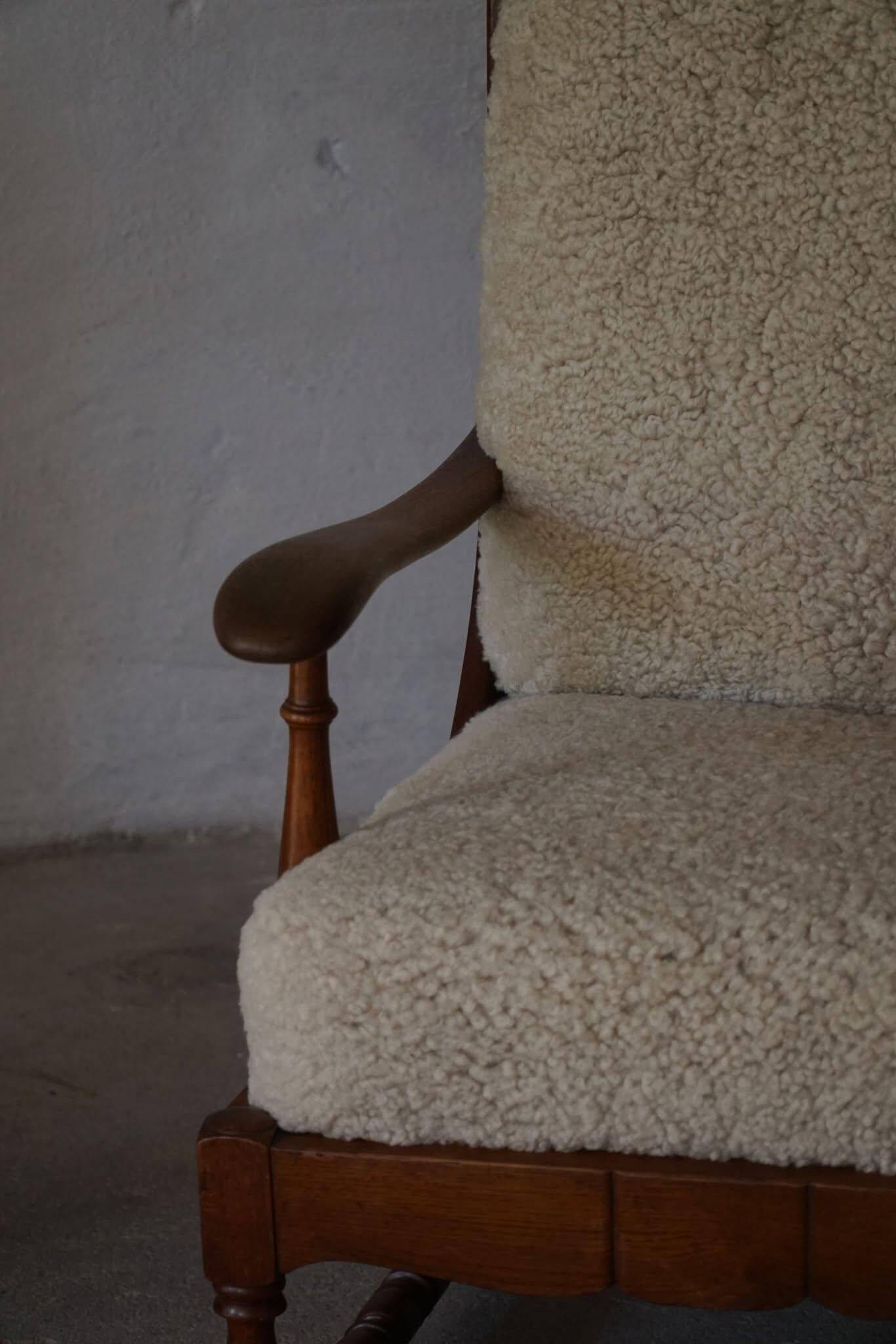 Modern Danish design, a pair of high-backed armchairs in oak and lambswool, 1950s.