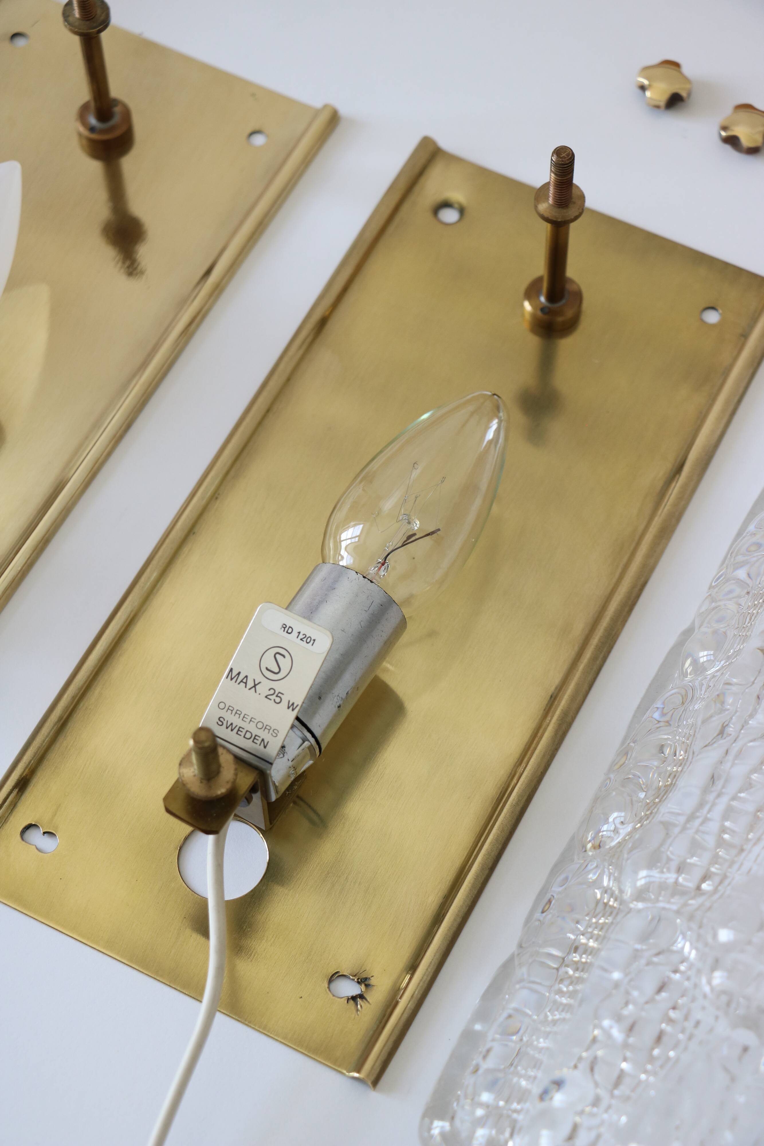 Pair of glass and brass wall lights by Carl Fagerlund for Orrefors.