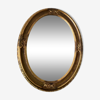 Large oval mirror in vintage golden stucco
