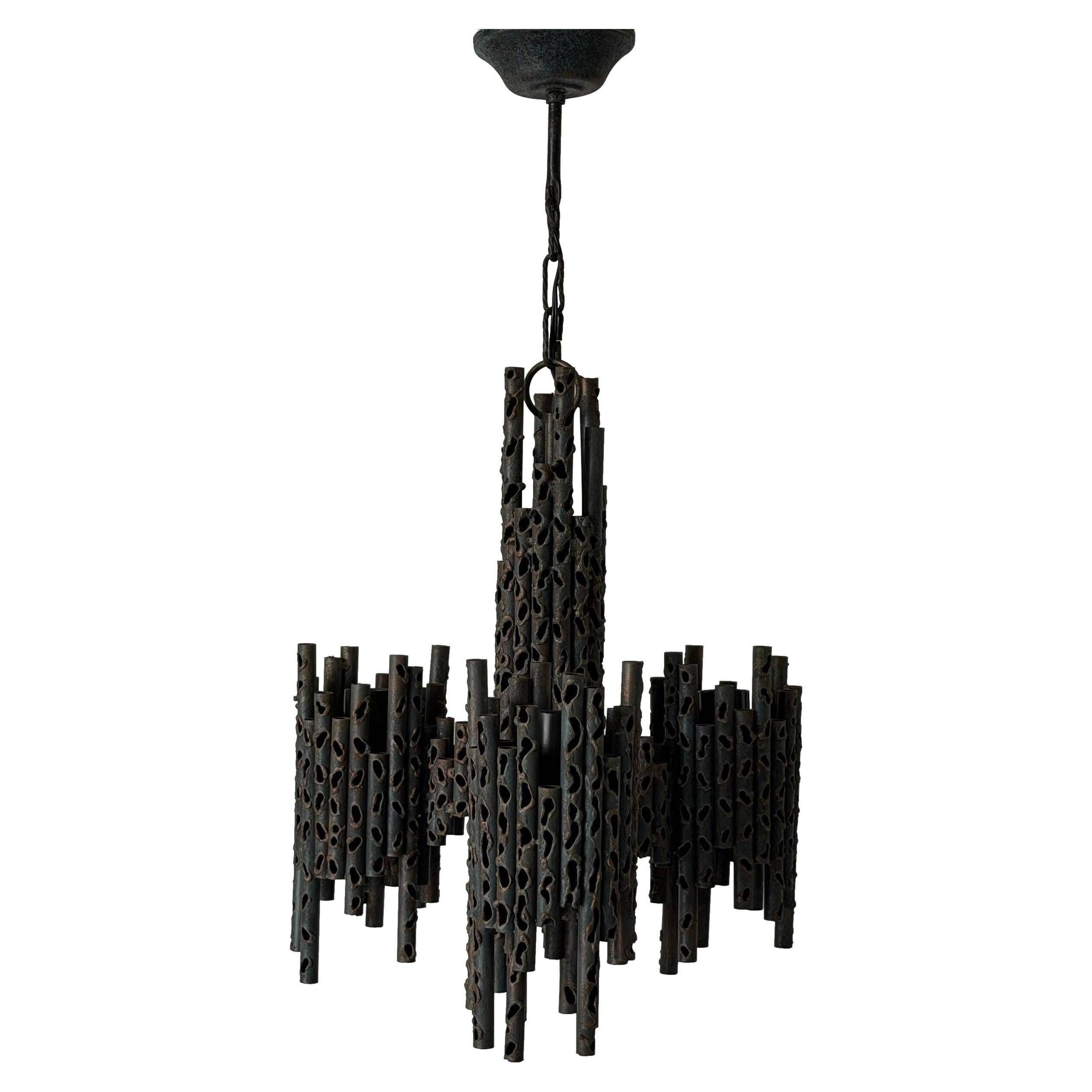 Three-armed suspended lamp in wrought iron, brutalist design, 1960s, Italy.