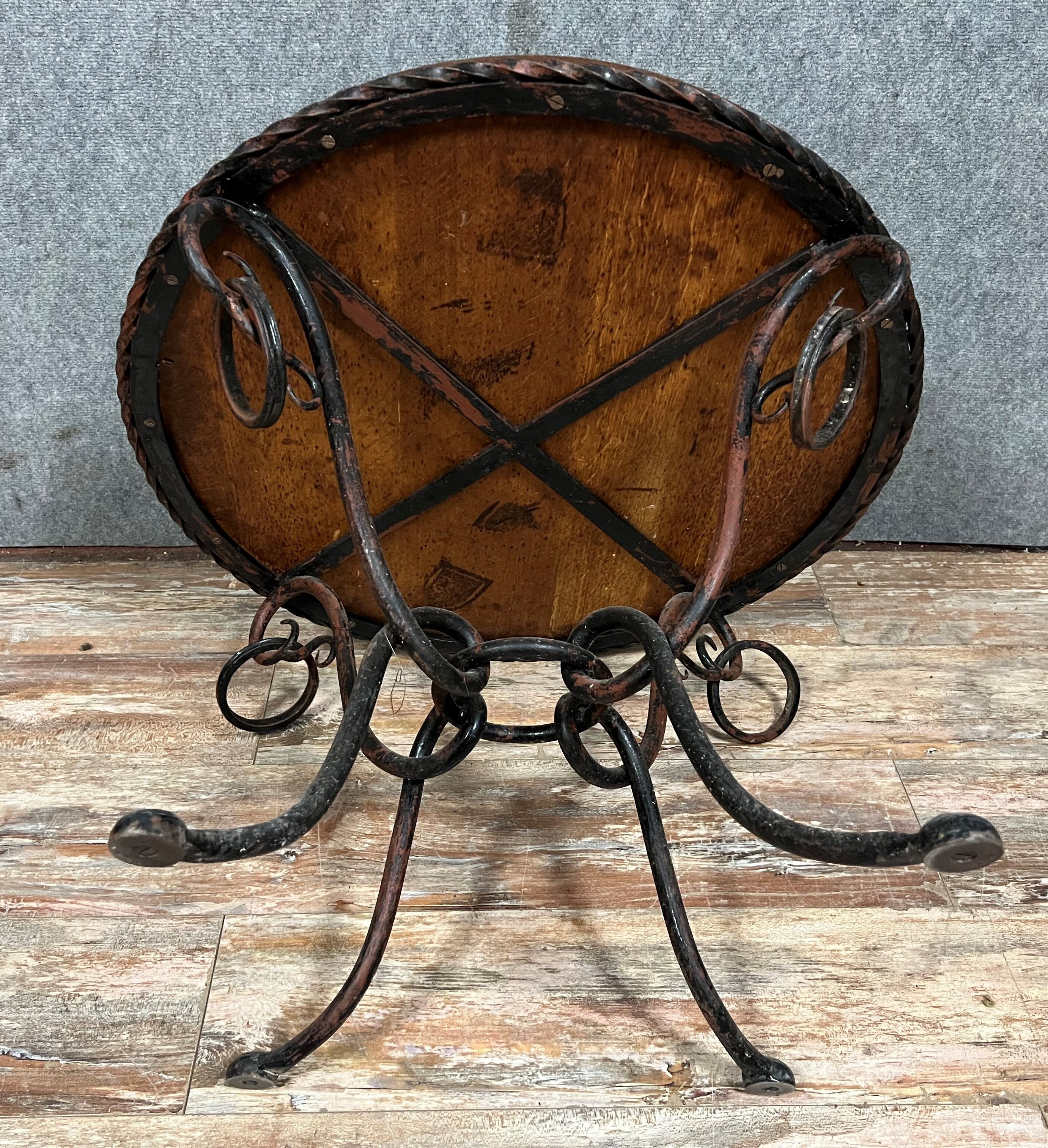 Hammered iron coffee table with circular wooden top