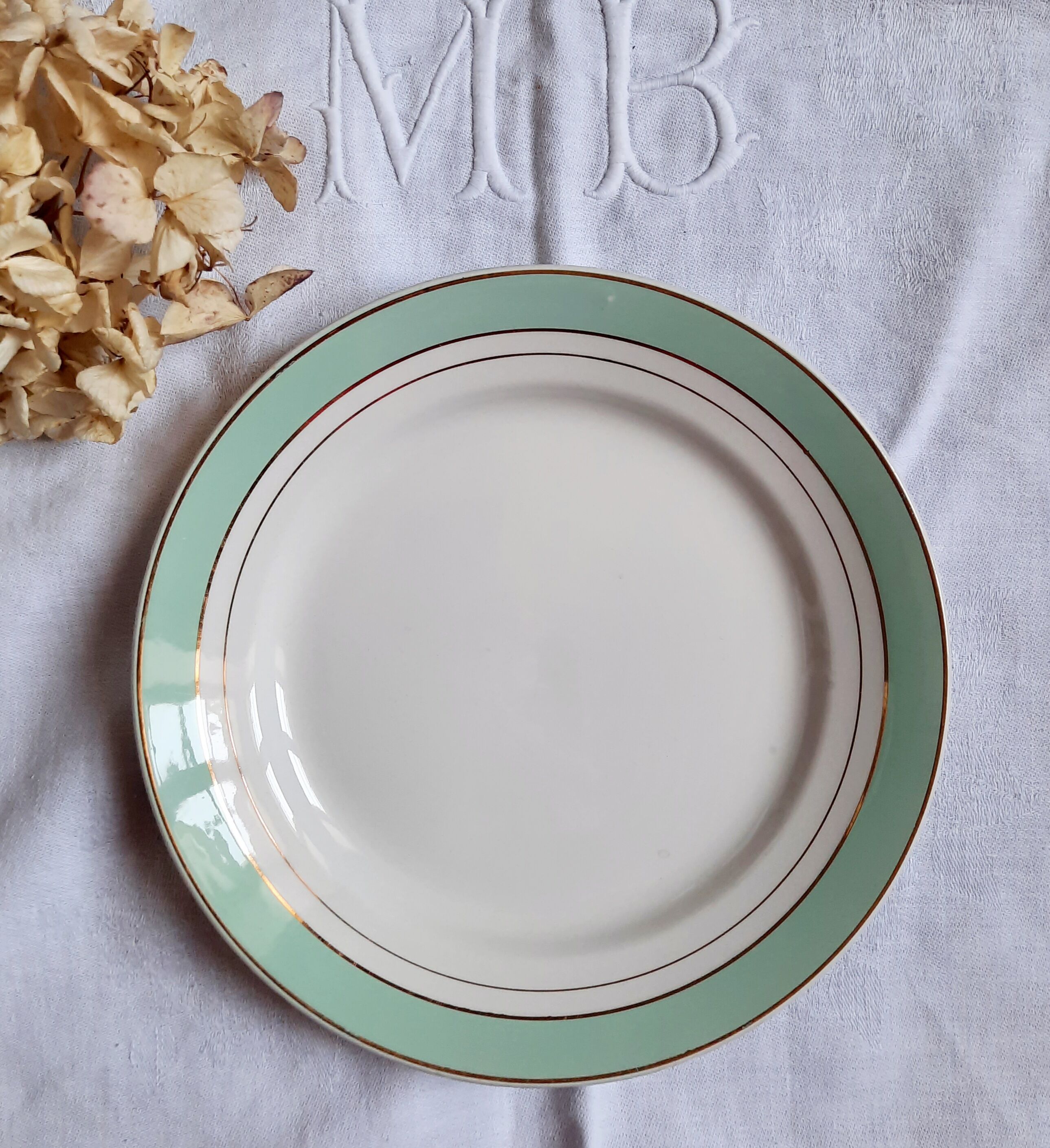 Flat antique earthenware plates with gilded edges