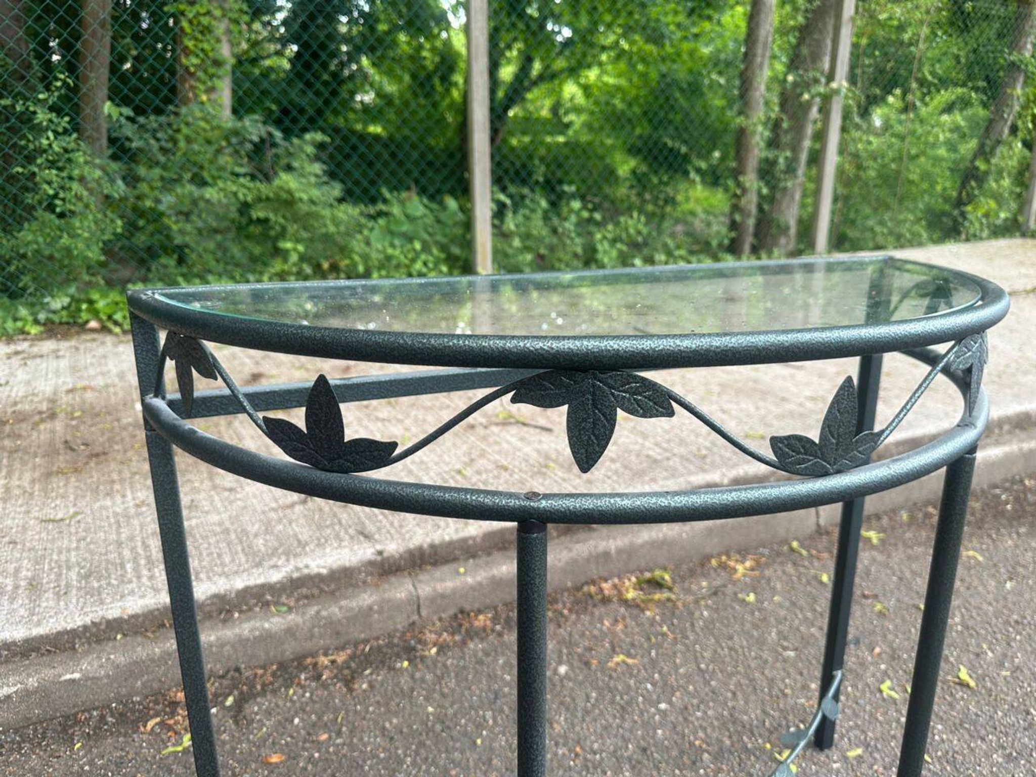 Grey-green wrought iron half-moon console with glass, 85cm.