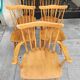 Four chairs and a Heywood Wakefield Windsor armchair. Vintage
