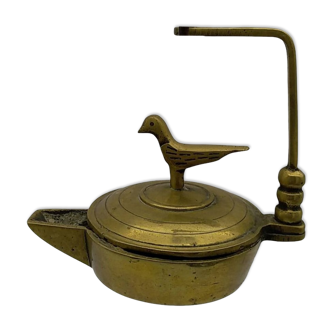 Brass pendant oil lamp with bird decoration.