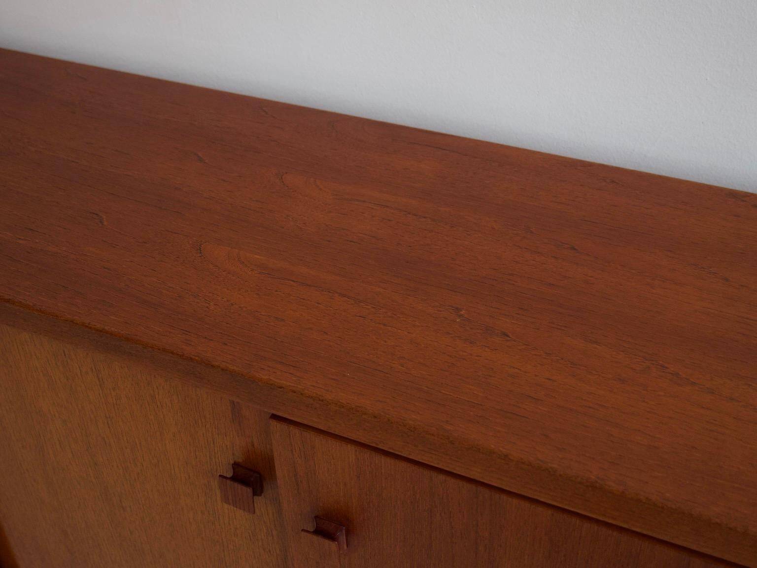 Modern mid-century teak sideboard with brass details.