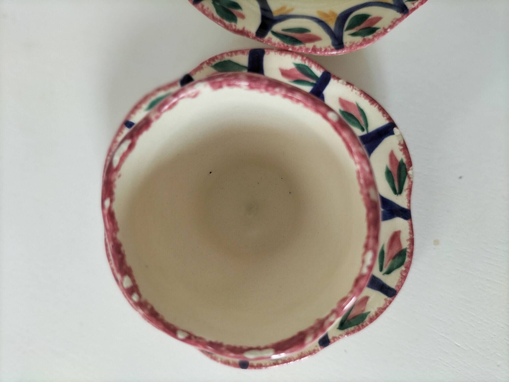 Pair of HB Quimper egg cups with integrated pedestal base, floral decoration