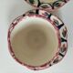 Pair of HB Quimper egg cups with integrated pedestal base, floral decoration