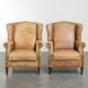 Set of two light cowhide wingback armchairs with a timeless English look