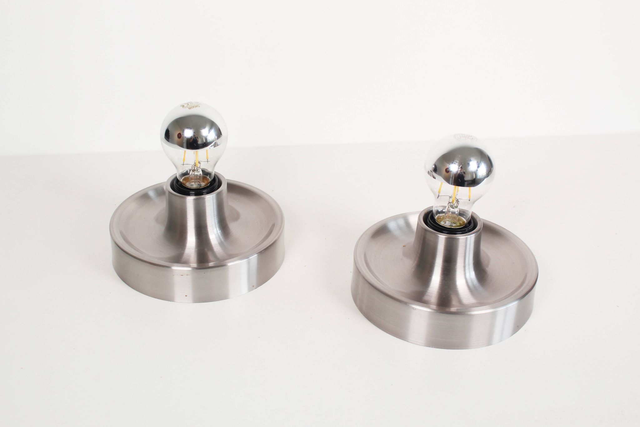Pair of petite Disc sconces selected by Charlotte Perriand for Les Arcs