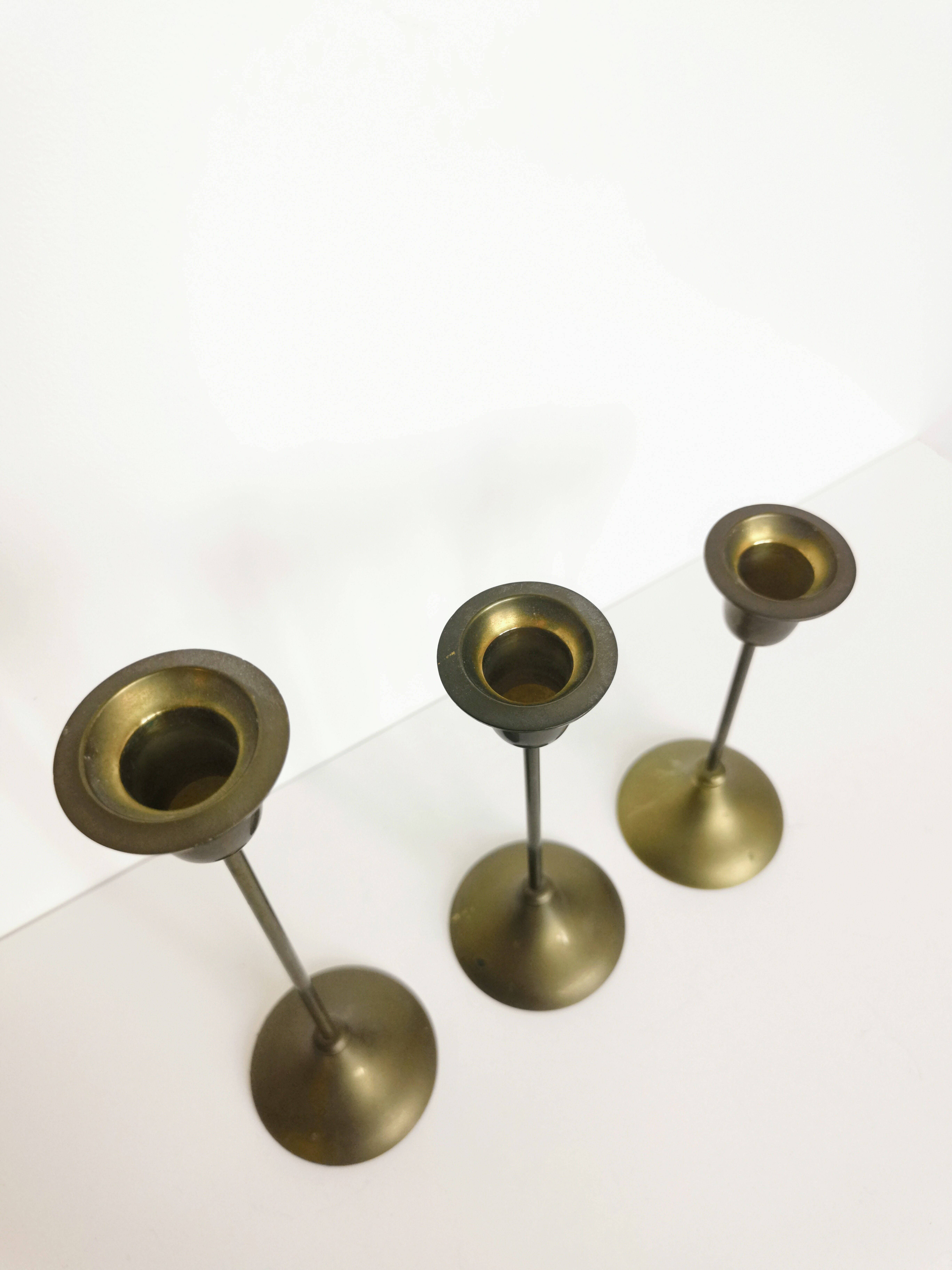 Trio of brass candlesticks