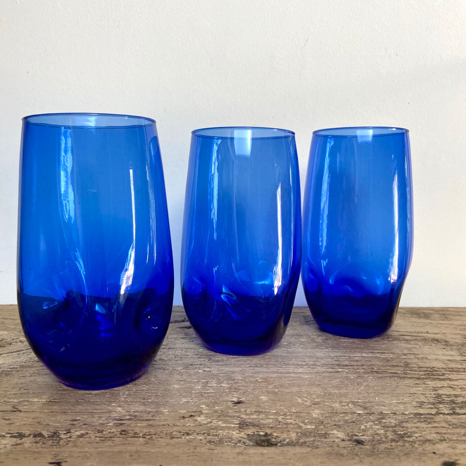 3 blue colored long drink glasses