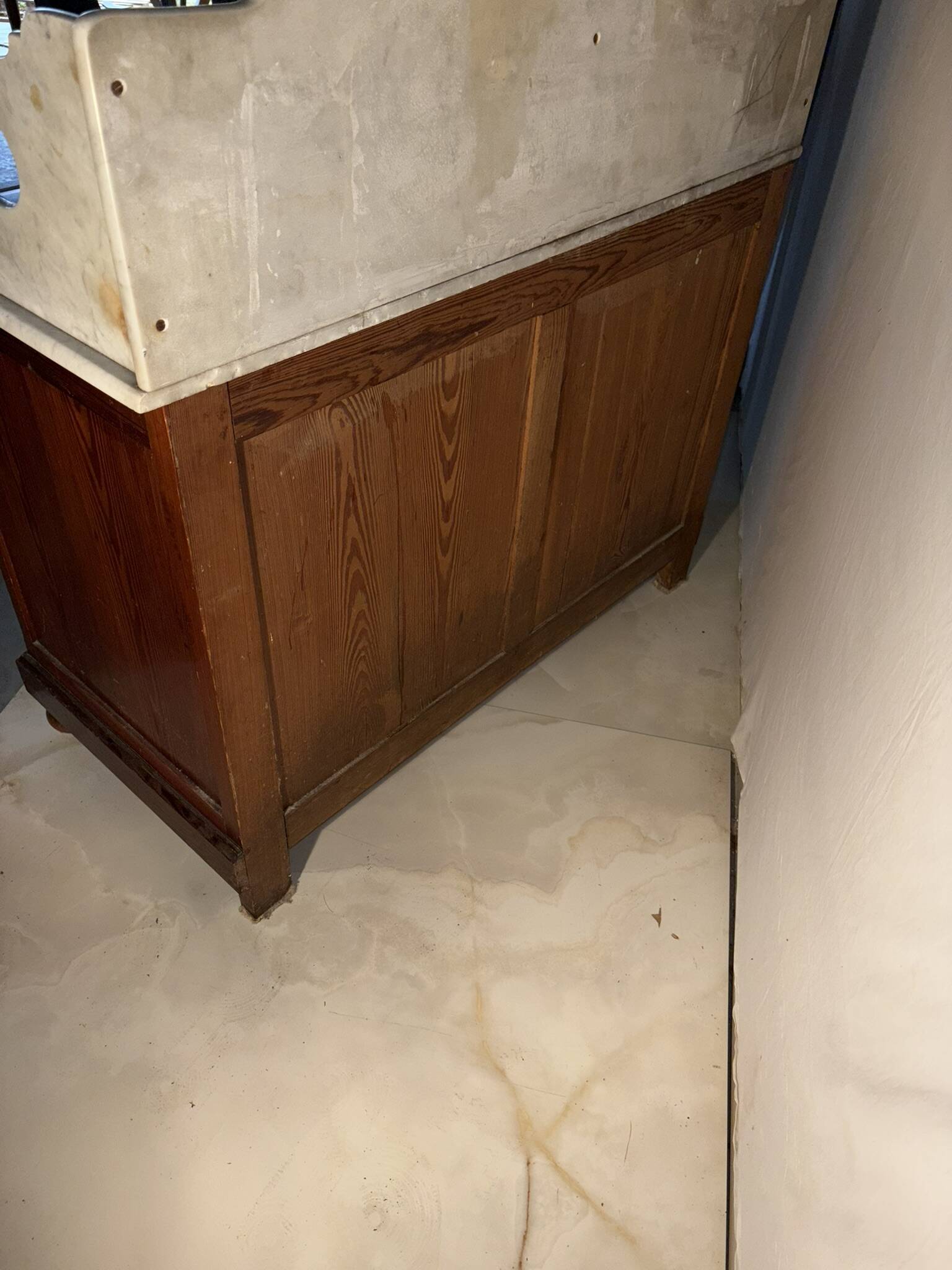 Antique wood and marble kitchen sideboard with carved backsplash