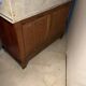 Antique wood and marble kitchen sideboard with carved backsplash